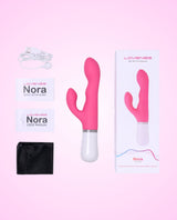 Nora by Lovense, a rotating rabbit dildo with packaging and user manual on a pink background.