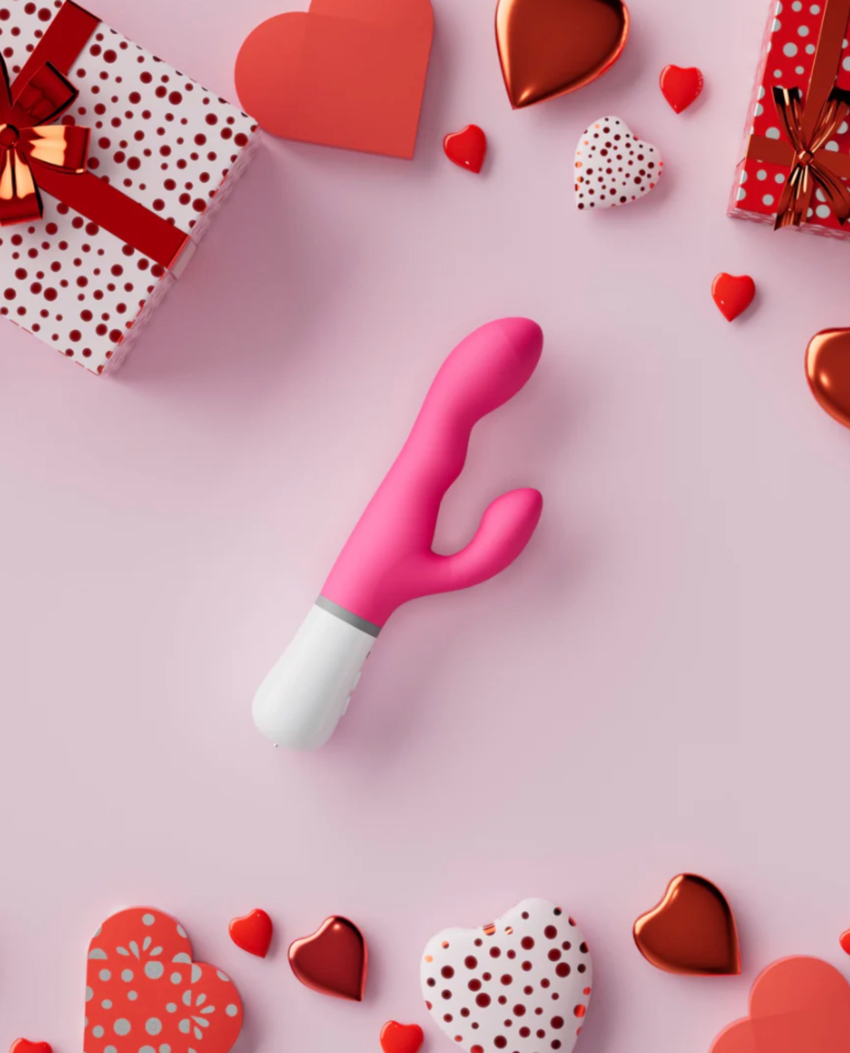 Nora by Lovense, a rotating rabbit dildo on a pink background with heart-shaped objects.