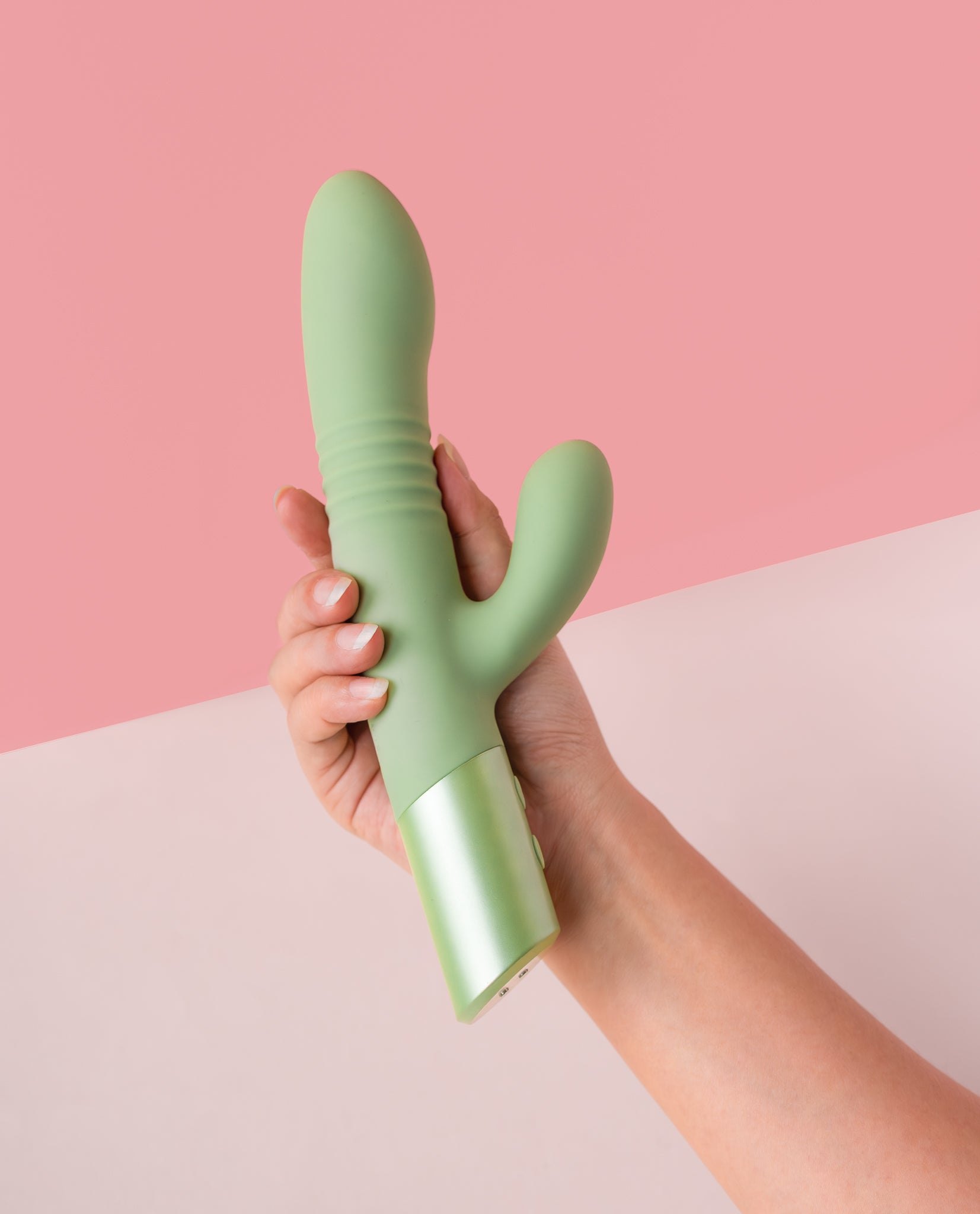 hand holding green mystique thruster rabbit vibrator