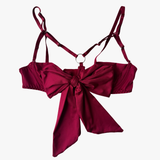 Red bra top with a large bow on a white background