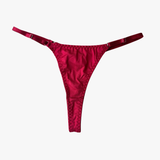 Red satin thong on a white background