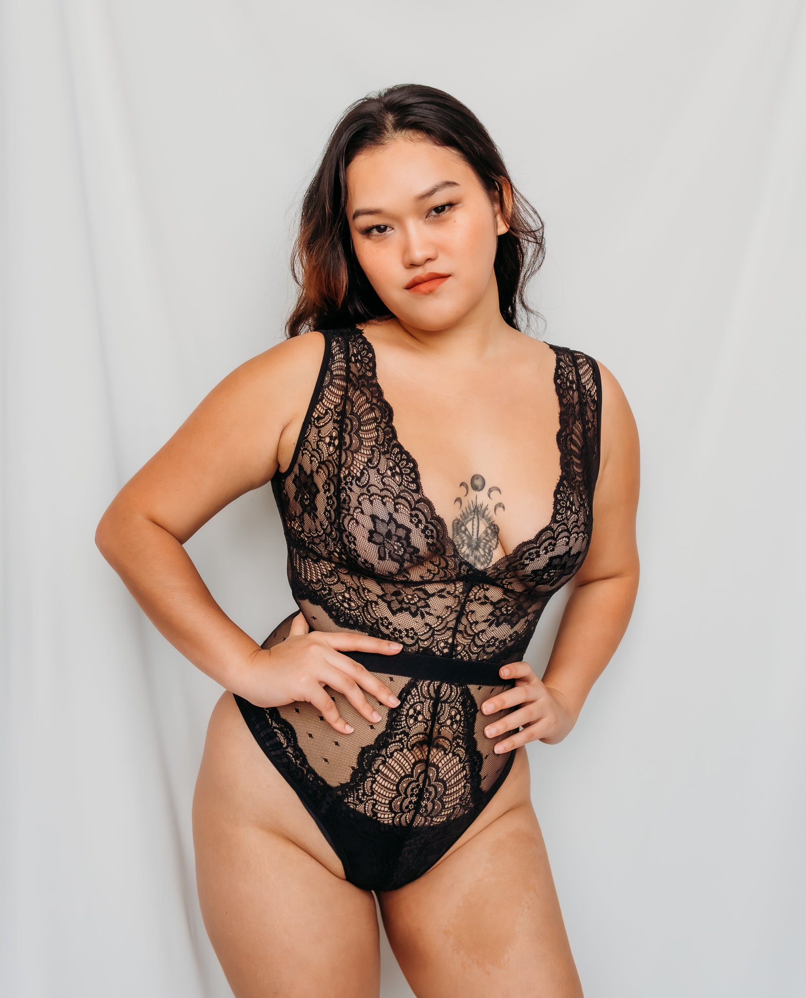 Woman wearing a black lace lingerie bodysuit