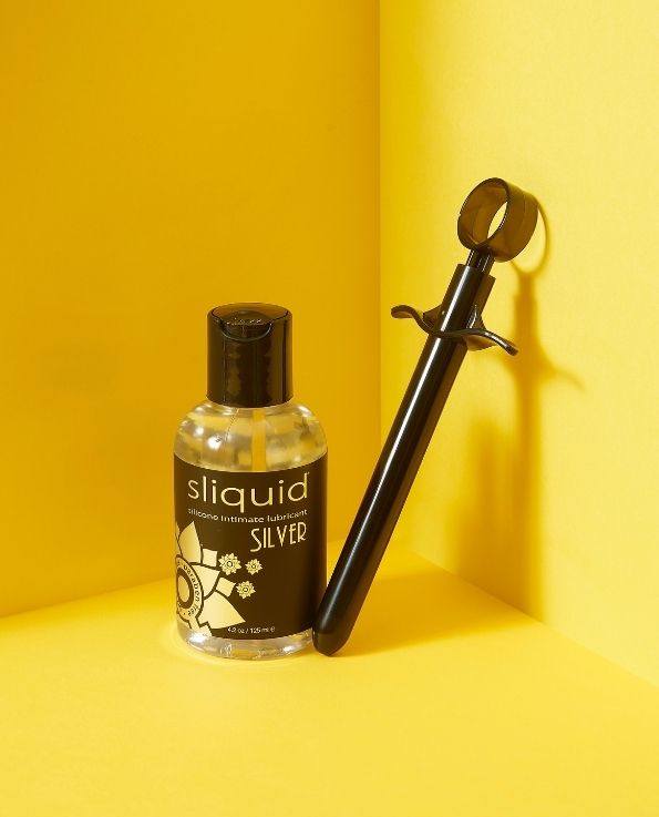 Black Lube Launcher with bottle of sliquid silicone lubricant
