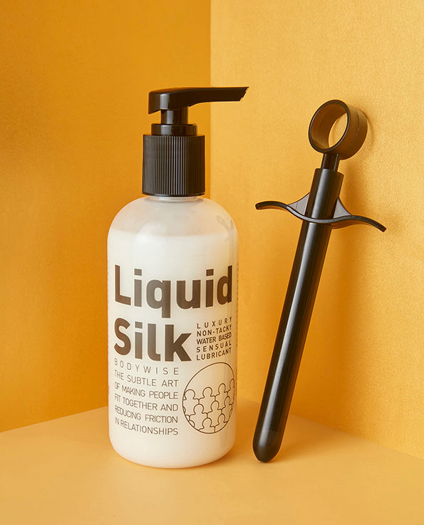  black Lube Launcher with bottle of liquid silk lubricant