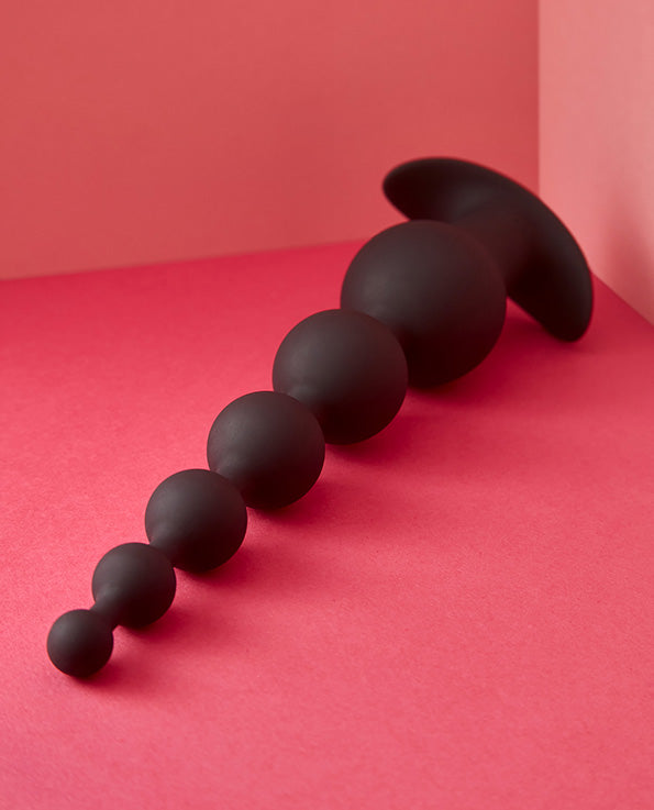 Black silicone anal beads on side