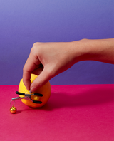 Hand holding Bell Nipple Clamps on a lemon