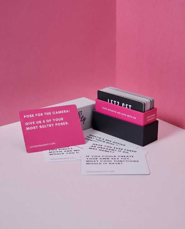 Box of Letz Get Naughty Cards, pink dare card, white truth cards