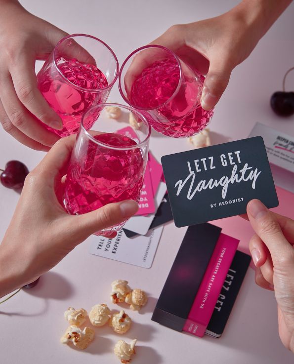 Box of Letz Get Naughty Cards, pink dare card, white truth card, pink drink