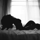 silhouette of woman arching her back on bed