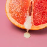 grapefruit with cream colored fluid dripping out