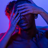 Woman experiencing ADHD overwhelm and emotional dysregulation, covering her face in frustration — a common symptom of adult ADHD in women