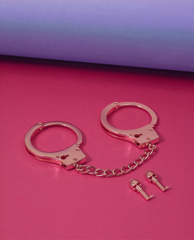 Nothing says, "Let's get a little naughty tonight" quite like these Rose Gold Hand Cuffs! 