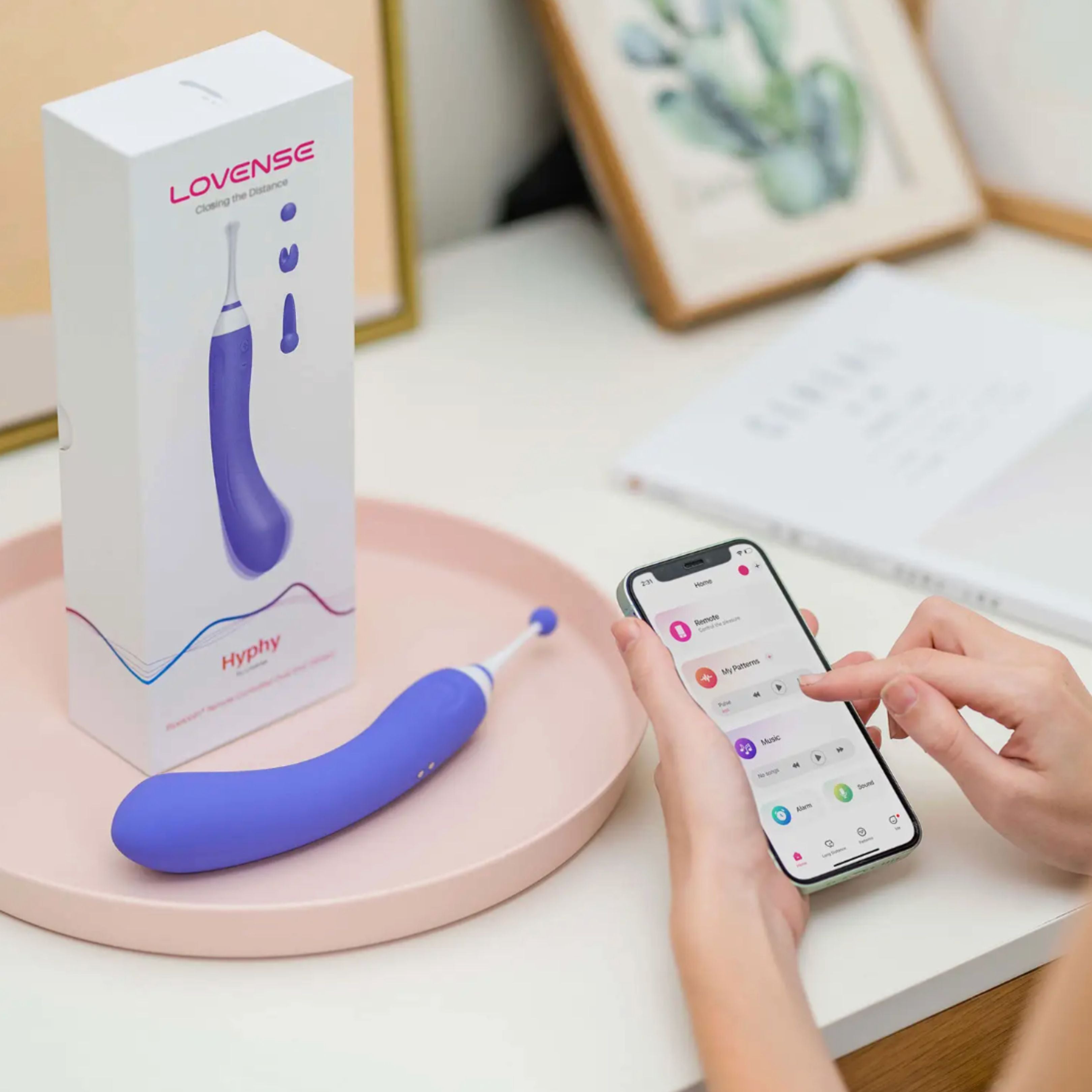 Lovense Hyphy App-Controlled Dual-End Pinpoint Vibrator's packaging with smartphone next to it