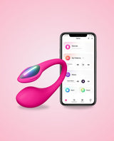 Lovense Lush Mini with a smartphone displaying an app interface on a pink background