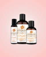 Three bottles of Sliquid Organics Sensation lubricant on a pink background