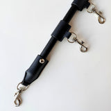 Close up of spreader bar with wooden pole and metal buckles