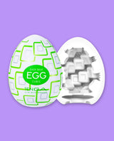 Tenga Egg Cubic packaging on a purple background