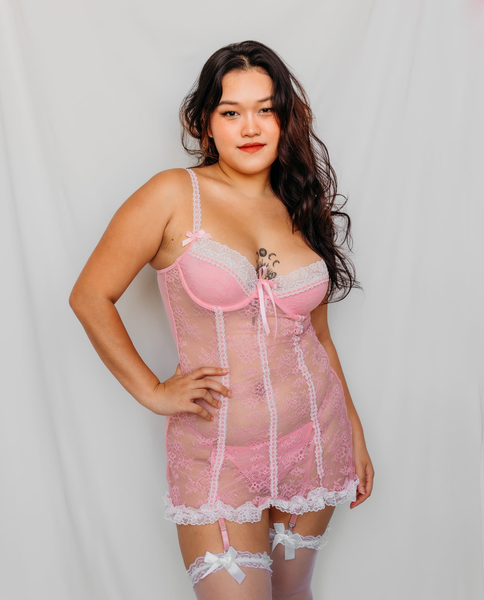 Woman wearing a pink babydoll lingerie with lace trim
