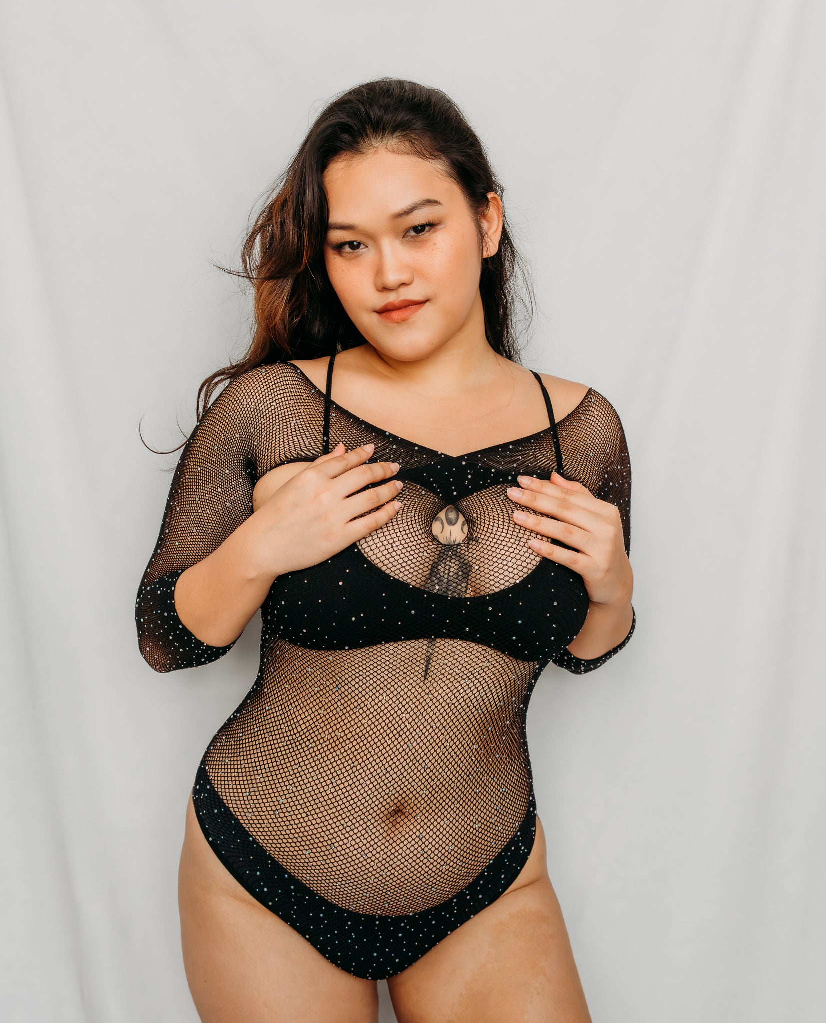 Woman wearing a black fishnet bodysuit