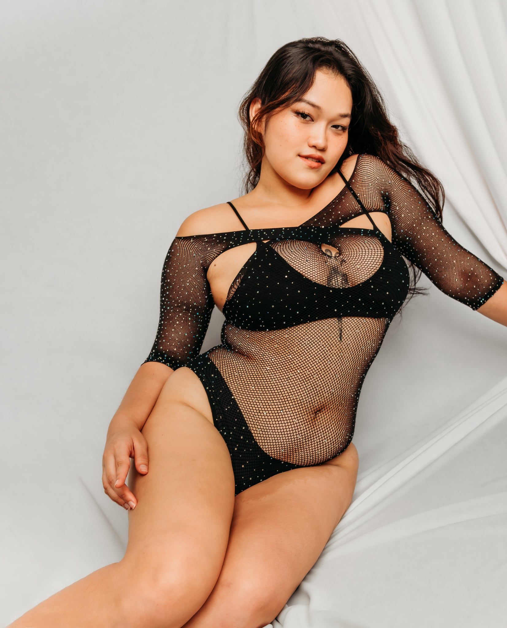 Woman wearing a black fishnet bodysuit