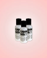 Bottles of Liquid Silk 50ml bundle of 3 on a pink gradient background