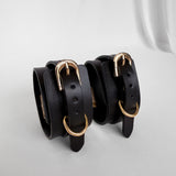 Three black leather bracelets with gold buckles