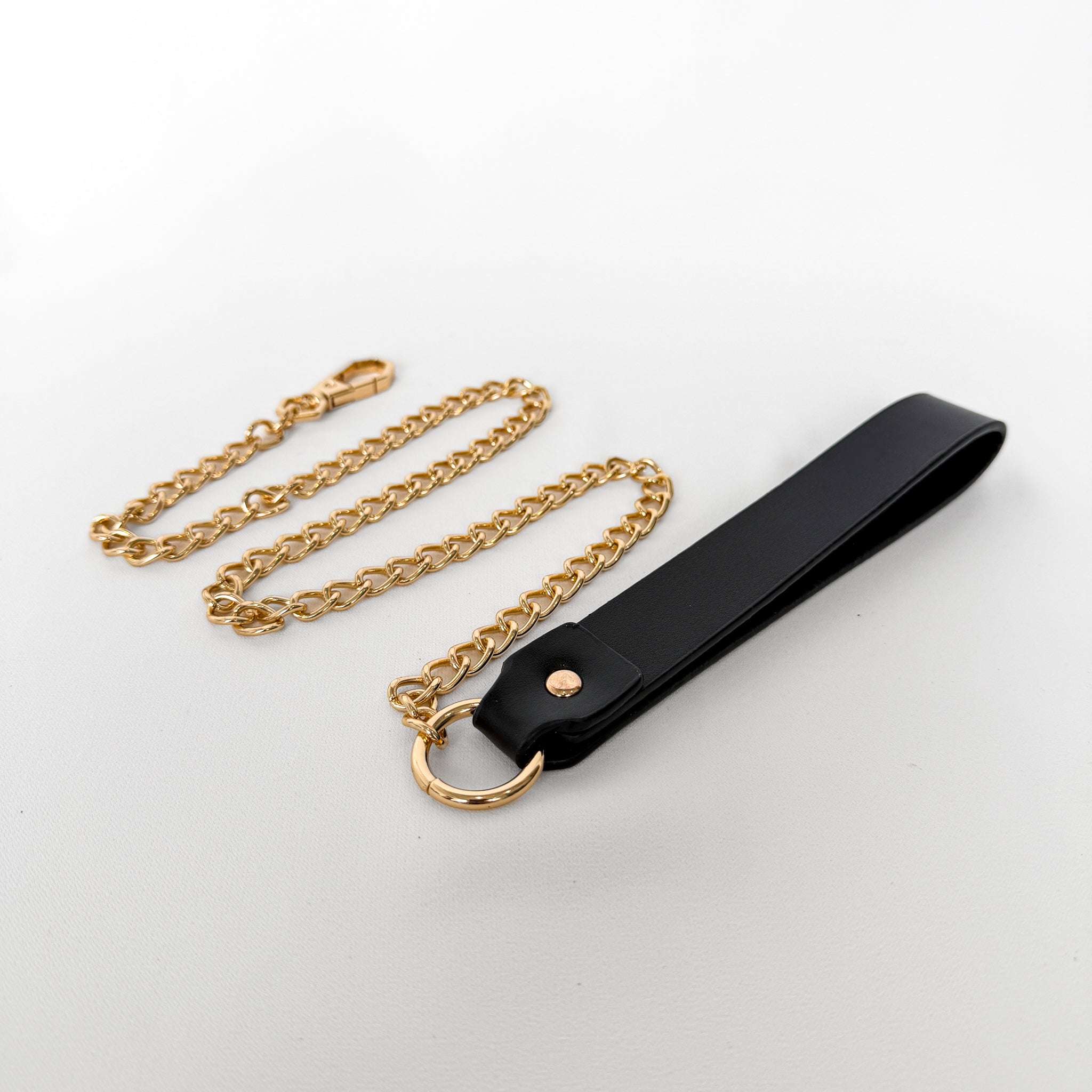 Black leather strap with gold chain leash