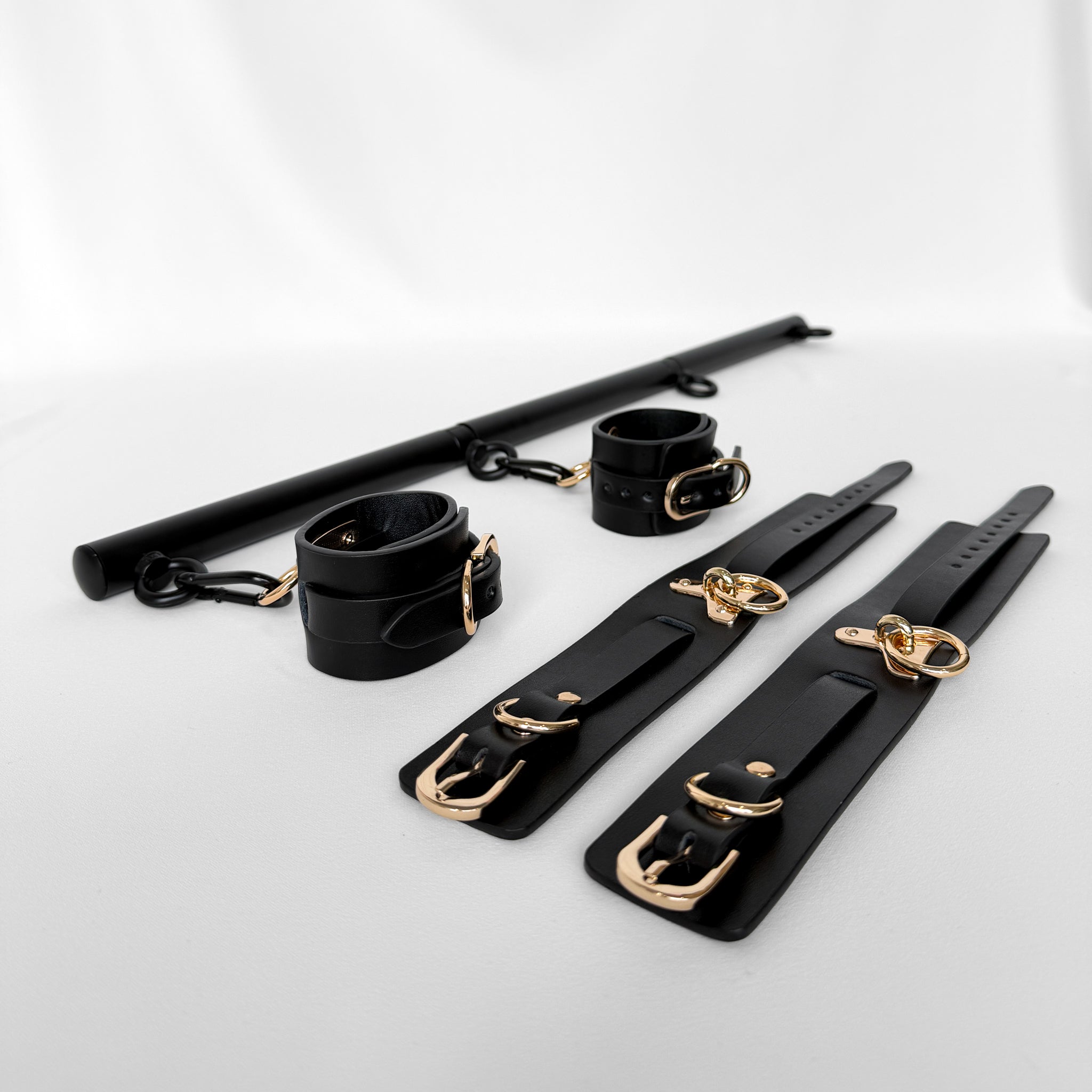 Black leather restraint spreader bar set with gold hardware