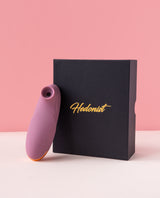 mystiva mini purple sucker next to a black box with 'Hedonist' branding