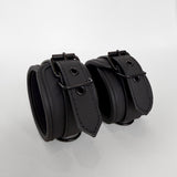Two black leather cuffs