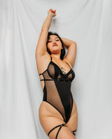 woman wearing a black strappy lingerie with gold ring