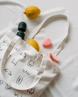 Canvas bag with black boobs and butt illustration and sex toys on a white background