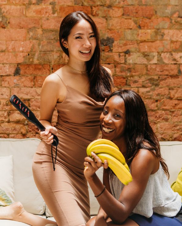 woman holding XOXO spank paddle, woman holding bunch of banana