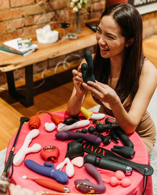 woman smiling while holding Landys anal stroker vibrator