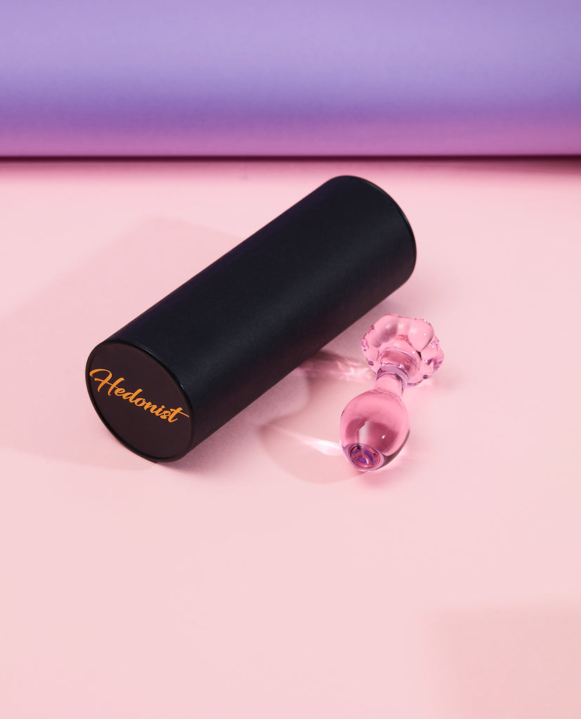 Pink blossom glass anal plug with long round black Hedonist packaging box
