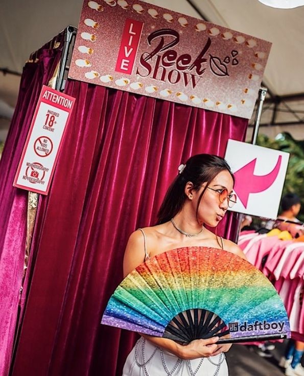 pink velvet curtains peek show booth, rainbow fan